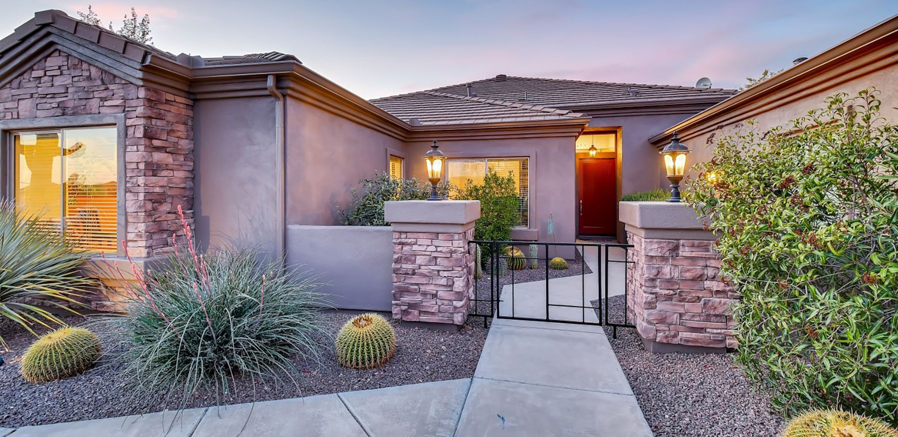Phoenix desert home at dusk with warm entry lighting
